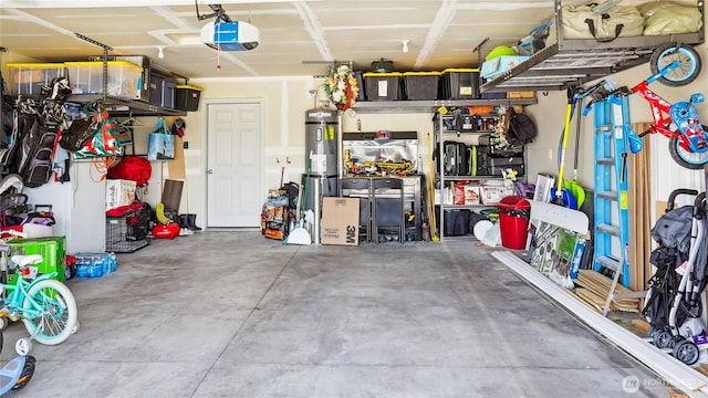 920 E Mt Adams St, Othello, WA 99344 - garage with a garage door opener and strapped water heater
