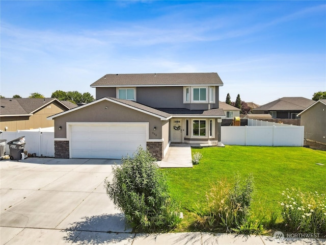 920 E Mt Adams St, Othello, WA 99344 - traditional home featuring stone siding, concrete driveway, an attached garage, and stucco siding