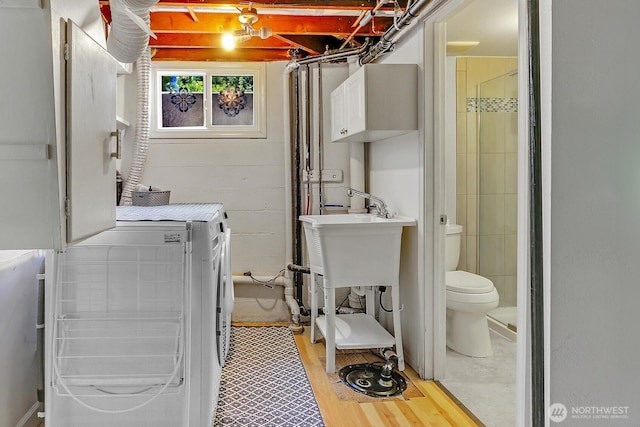 11729 Phinney Ave N, Seattle, WA 98133 - washroom with cabinet space, washing machine and clothes dryer, and light wood finished floors