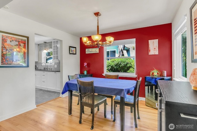 11729 Phinney Ave N, Seattle, WA 98133 - dining area with a chandelier, light wood-type flooring, and healthy amount of natural light