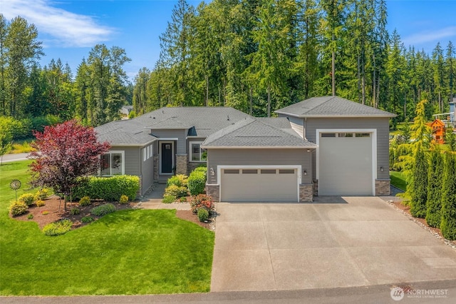 11306 143rd Dr NE, Lake Stevens, WA 98258 - view of front of house with an attached garage, driveway, a front lawn, and stone siding