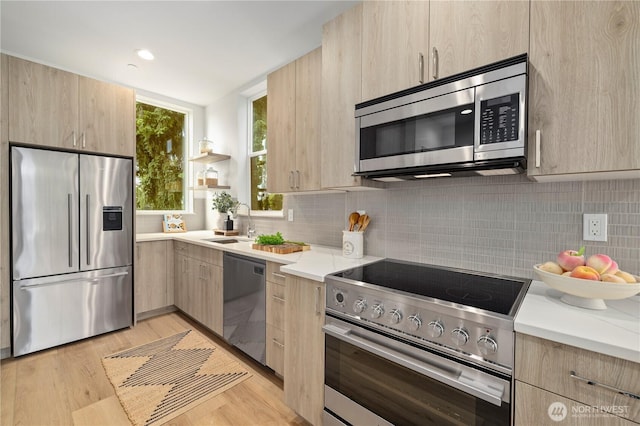 7013 9th Ave NE, Seattle, WA 98115 - kitchen featuring appliances with stainless steel finishes, light brown cabinets, light countertops, and decorative backsplash