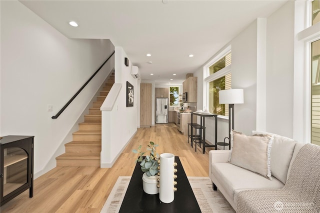7013 9th Ave NE, Seattle, WA 98115 - living area featuring light wood finished floors, stairway, recessed lighting, and a wall mounted AC