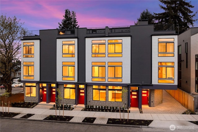 7013 9th Ave NE, Seattle, WA 98115 - back of property at dusk featuring brick siding