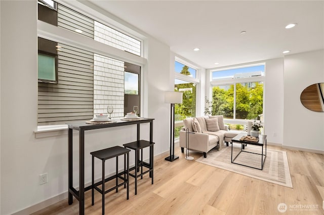 7013 9th Ave NE, Seattle, WA 98115 - living area featuring healthy amount of natural light, light wood-type flooring, recessed lighting, and expansive windows