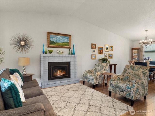 4607 225th Street Ct E, Spanaway, WA 98387 - living area with lofted ceiling, a chandelier, wood finished floors, and a fireplace