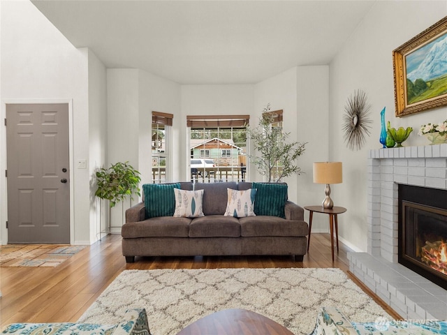 4607 225th Street Ct E, Spanaway, WA 98387 - living room featuring hardwood / wood-style flooring and a brick fireplace