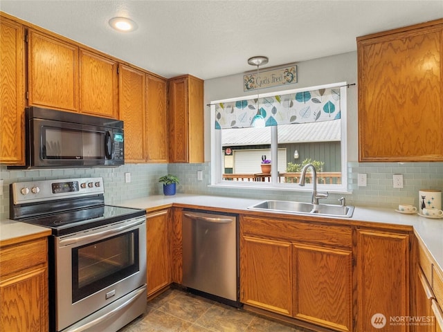 4607 225th Street Ct E, Spanaway, WA 98387 - kitchen featuring stainless steel appliances, brown cabinetry, and tasteful backsplash