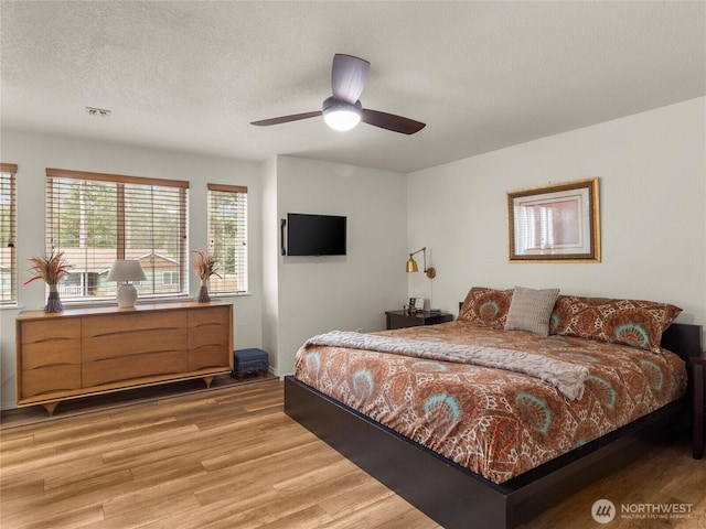 4607 225th Street Ct E, Spanaway, WA 98387 - bedroom with light wood-style floors, a textured ceiling, and ceiling fan