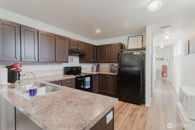 7543 Wooldridge Dr, Blaine, WA 98230 - kitchen featuring black appliances, dark brown cabinets, light countertops, under cabinet range hood, and a peninsula