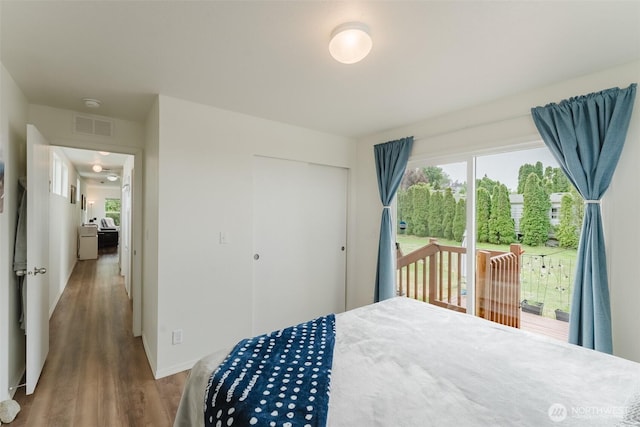 7543 Wooldridge Dr, Blaine, WA 98230 - bedroom with a closet, access to exterior, and wood finished floors