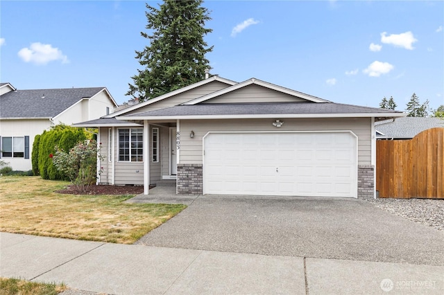 8803 136th St E, Puyallup, WA 98373 - single story home with asphalt driveway, an attached garage, and brick siding