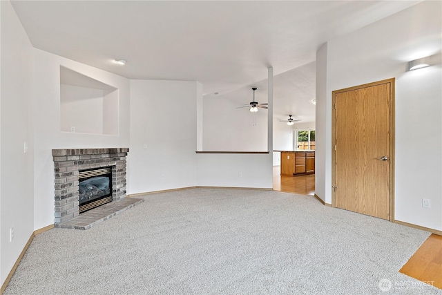 8803 136th St E, Puyallup, WA 98373 - unfurnished living room with a ceiling fan, a brick fireplace, light carpet, and lofted ceiling