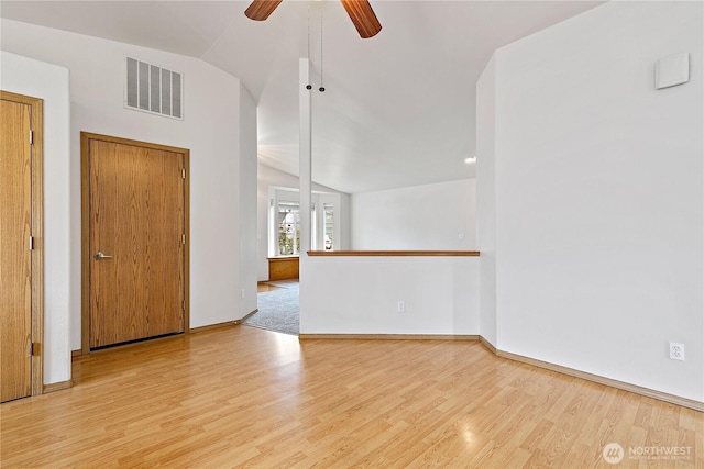 8803 136th St E, Puyallup, WA 98373 - empty room with wood finished floors, a ceiling fan, and vaulted ceiling