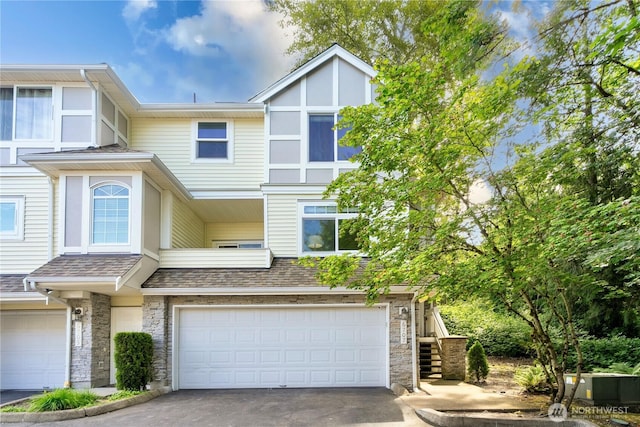 6707 SE Cougar Mountain Way Unit 2, Bellevue, WA 98006 - multi unit property featuring asphalt driveway, an attached garage, stone siding, and stairway