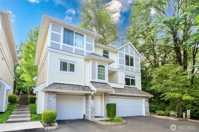 6707 SE Cougar Mountain Way Unit 2, Bellevue, WA 98006 - view of front of home with stone siding, a garage, asphalt driveway, and roof with shingles