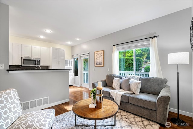 6707 SE Cougar Mountain Way Unit 2, Bellevue, WA 98006 - living area featuring wood finished floors and recessed lighting