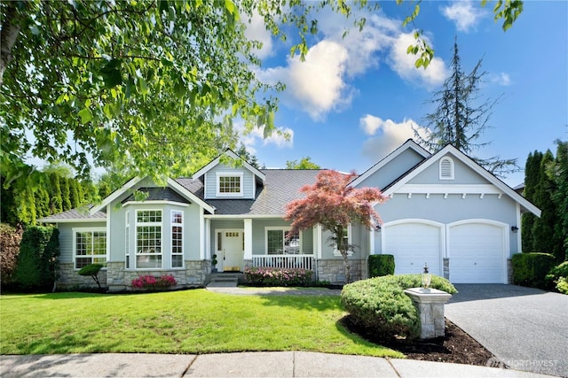 1912 243rd Pl SE, Bothell, WA 98021 - craftsman house with stone siding, covered porch, an attached garage, and driveway