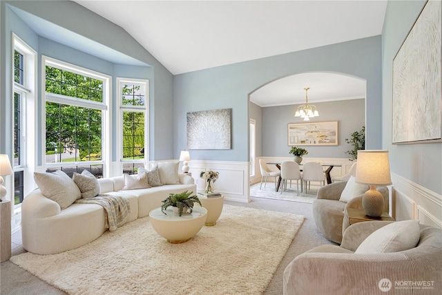 1912 243rd Pl SE, Bothell, WA 98021 - carpeted living room with arched walkways, a wainscoted wall, a chandelier, and lofted ceiling