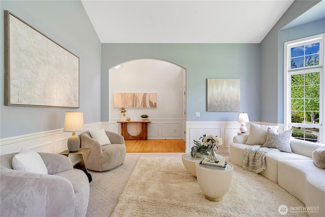 1912 243rd Pl SE, Bothell, WA 98021 - living room with vaulted ceiling, a wainscoted wall, a decorative wall, and arched walkways