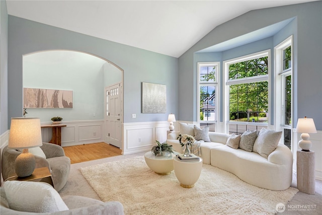 1912 243rd Pl SE, Bothell, WA 98021 - living area featuring plenty of natural light, a wainscoted wall, vaulted ceiling, wood finished floors, and arched walkways