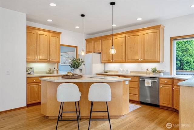 1912 243rd Pl SE, Bothell, WA 98021 - kitchen with stainless steel dishwasher, a center island, a kitchen breakfast bar, white fridge with ice dispenser, and light wood-style floors