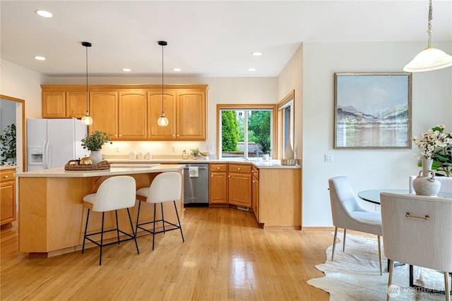 1912 243rd Pl SE, Bothell, WA 98021 - kitchen with dishwasher, white fridge with ice dispenser, a center island, light countertops, and light wood-style flooring