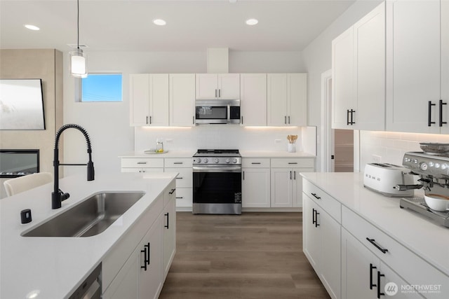 13325 SE 238th Pl Unit 15, Kent, WA 98042 - kitchen with stainless steel appliances, decorative backsplash, white cabinets, wood finished floors, and recessed lighting