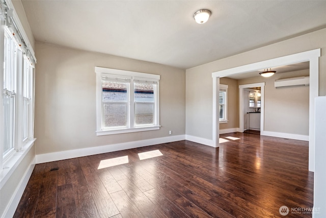 1306 Main St, Sumner, WA 98390 - spare room with wood finished floors and an AC wall unit