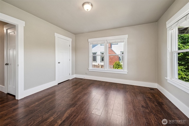 1306 Main St, Sumner, WA 98390 - empty room with plenty of natural light and dark wood finished floors