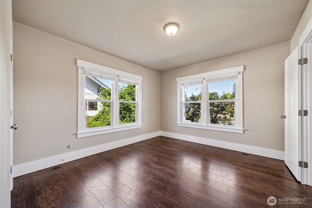1306 Main St, Sumner, WA 98390 - spare room featuring baseboards and dark wood finished floors