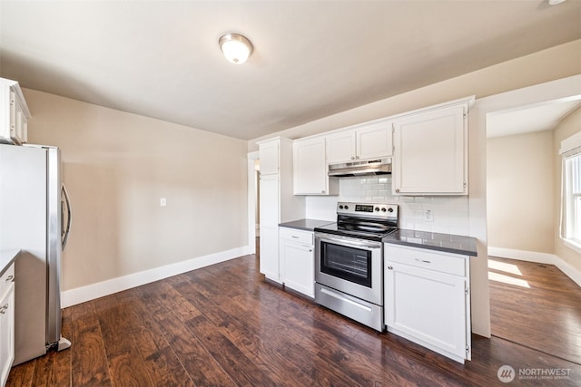 1306 Main St, Sumner, WA 98390 - kitchen with appliances with stainless steel finishes, under cabinet range hood, dark wood-type flooring, backsplash, and dark countertops