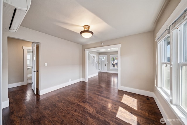1306 Main St, Sumner, WA 98390 - unfurnished room with dark wood finished floors, stairway, and a wall mounted air conditioner