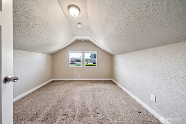 1306 Main St, Sumner, WA 98390 - bonus room featuring a textured ceiling, lofted ceiling, a textured wall, and carpet floors