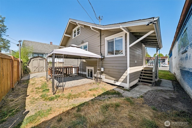 1306 Main St, Sumner, WA 98390 - back of property with a storage unit, a gazebo, and a patio