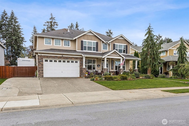 8316 230th Street Ct E, Graham, WA 98338 - craftsman-style house with a porch, concrete driveway, board and batten siding, an attached garage, and stone siding