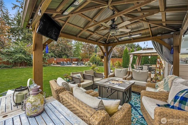 8316 230th Street Ct E, Graham, WA 98338 - fenced backyard featuring a gazebo, an outdoor living space with a fire pit, and a ceiling fan