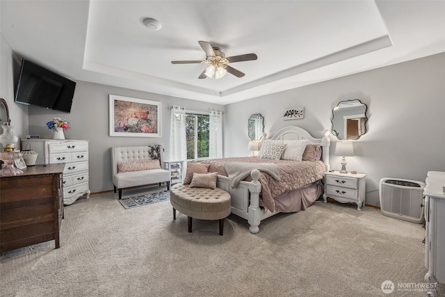 8316 230th Street Ct E, Graham, WA 98338 - bedroom featuring a tray ceiling, light carpet, and ceiling fan