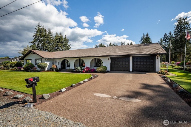 9802 124th St E, Puyallup, WA 98373 - ranch-style house featuring a tile roof, an attached garage, asphalt driveway, and stucco siding