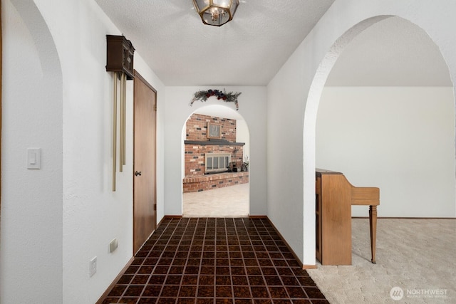 9802 124th St E, Puyallup, WA 98373 - corridor with arched walkways, carpet, and a textured ceiling