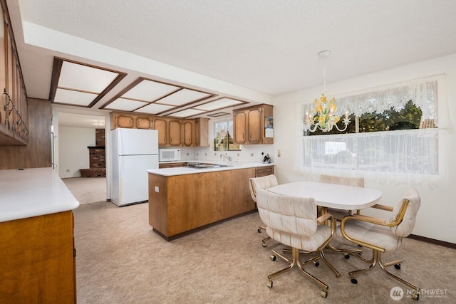 9802 124th St E, Puyallup, WA 98373 - kitchen with white appliances, brown cabinetry, light colored carpet, and light countertops