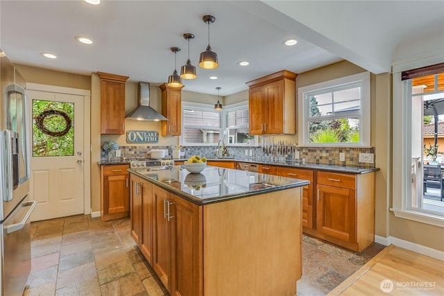 141 18th Ave, Kirkland, WA 98033 - kitchen featuring wall chimney range hood, high quality fridge, stone tile flooring, dark stone countertops, and hanging light fixtures