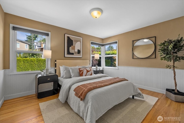 141 18th Ave, Kirkland, WA 98033 - bedroom with a wainscoted wall, multiple windows, and light wood-type flooring