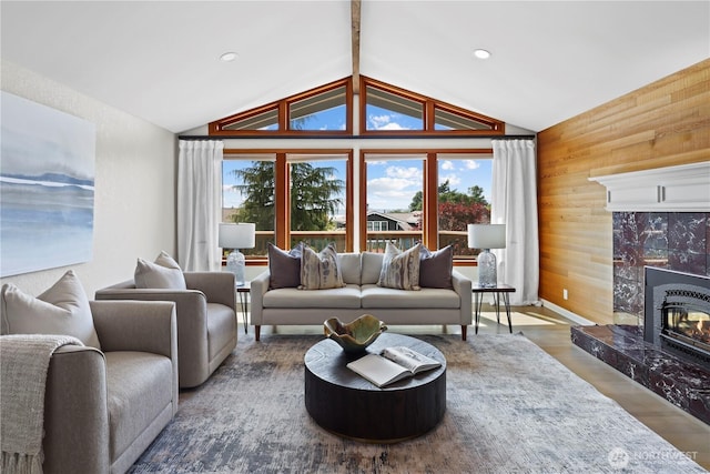 6210 105th Ave NE, Kirkland, WA 98033 - living room featuring wooden walls, vaulted ceiling, wood finished floors, a premium fireplace, and recessed lighting