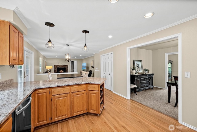 1920 11th Street Pl SW, Puyallup, WA 98371 - kitchen featuring a peninsula, stainless steel dishwasher, a lit fireplace, crown molding, and light stone counters