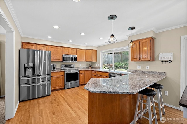 1920 11th Street Pl SW, Puyallup, WA 98371 - kitchen featuring stainless steel appliances, a peninsula, crown molding, recessed lighting, and a breakfast bar area