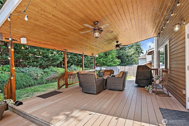 1920 11th Street Pl SW, Puyallup, WA 98371 - wooden deck with area for grilling, a fenced backyard, ceiling fan, and outdoor dining space