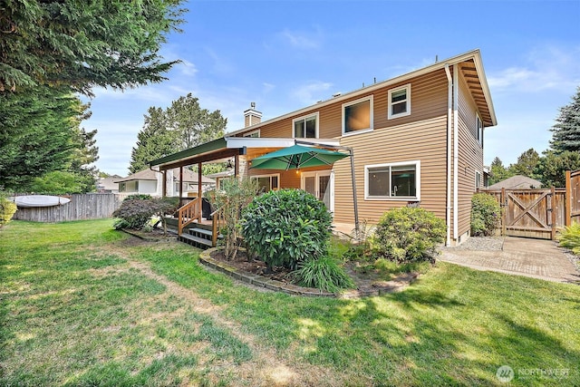 1920 11th Street Pl SW, Puyallup, WA 98371 - back of house featuring a wooden deck, a gate, and a chimney
