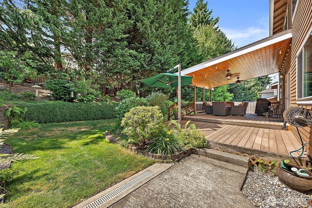 1920 11th Street Pl SW, Puyallup, WA 98371 - view of grassy yard with ceiling fan, a wooden deck, and an outdoor hangout area