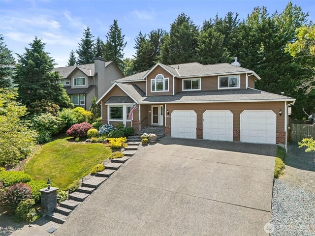 1920 11th Street Pl SW, Puyallup, WA 98371 - view of front of home featuring asphalt driveway and a garage
